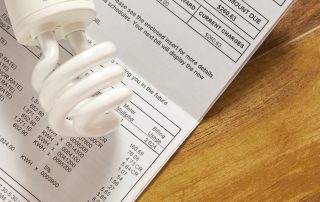 Electric bill with light bulb on a table
